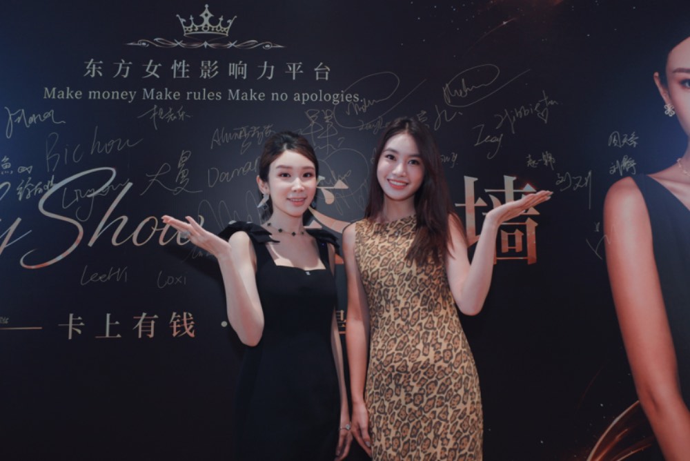 Madison with a guest at the signature wall
